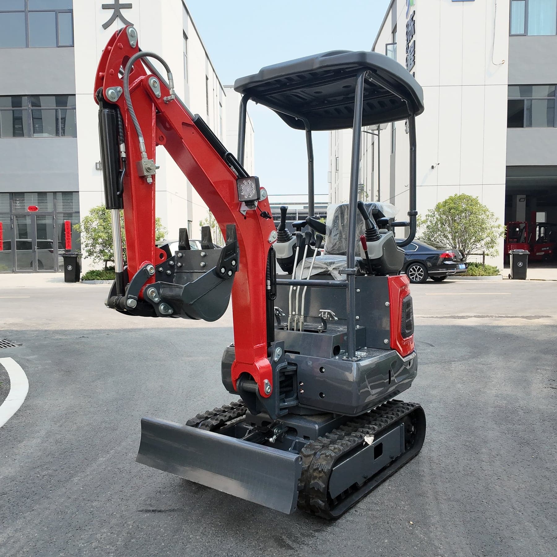 Red and grey mini excavator front side view for compact digging equipment